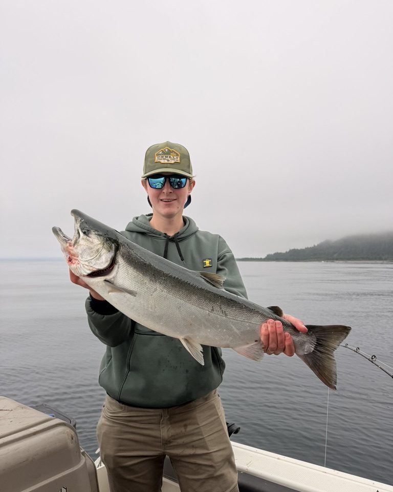Taylor Wall on the water in Southcentral Alaska holding a king salmon